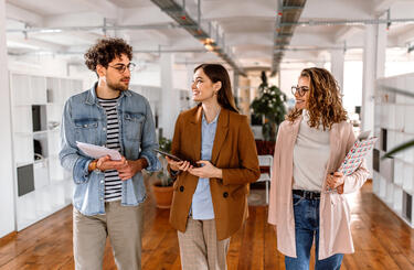 group of people walking in office