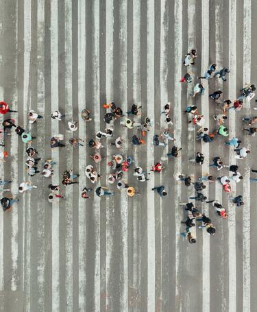 Leadership_People Forming an Arrow High Angle View Of People forming and arrow on the street
