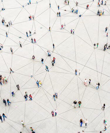 GettyImages-1180187740 People walking and interconnected with joined up lines on the ground