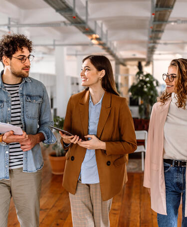 group of people walking in office