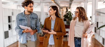 group of people walking in office