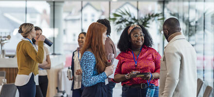 CQI Networking Opportunities a group of mixed age professionals who are taking advantage of a networking opportunity at a business conference